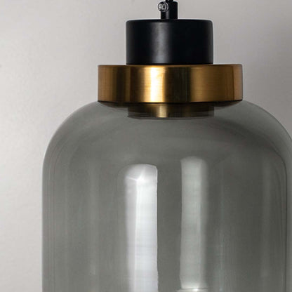 Closeup of smoked glass pendant light with golden accent and black cord perfect modern ceiling lamp for home interior styling.