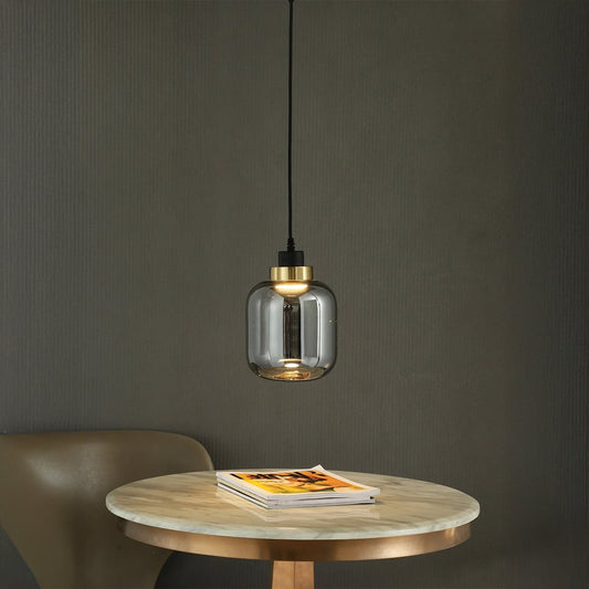 Modern smoked glass pendant light with golden accent elegant hanging lamp for dining room table and stylish living interiors