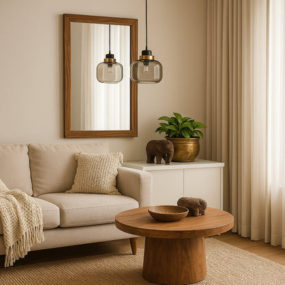 Elegant smoked glass pendant light with golden top hanging above dining chair and table modern lighting for stylish interiors.