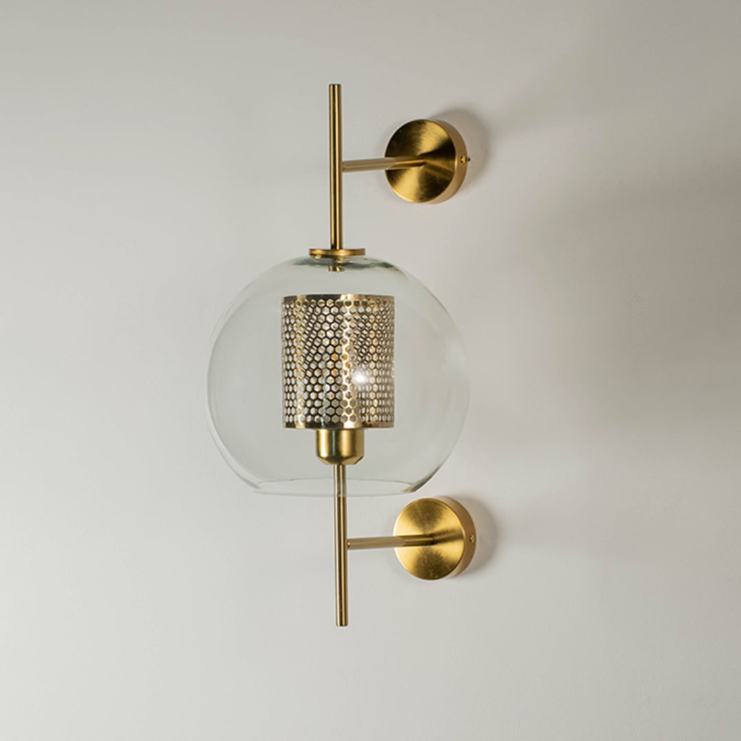 Pendant light with a glass shade and gold frame displayed without illumination against a white background showcasing its refined design.