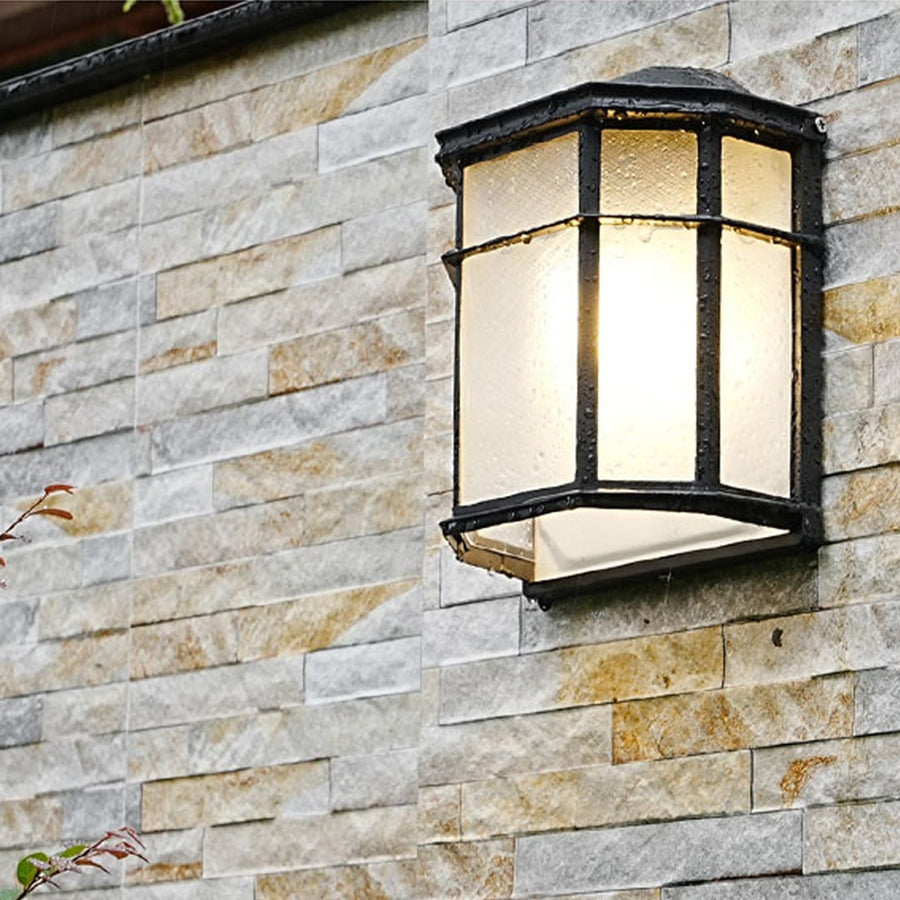 Outdoor wall light mounted on a stone wall illuminating the exterior with a warm glow for stylish outdoor lighting.