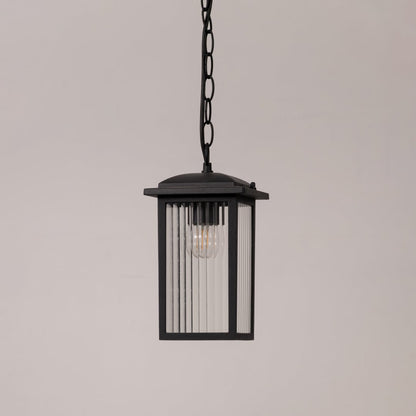 Black metal hanging lantern with ribbed glass shown switched off on white background for outdoor porch and patio decor.