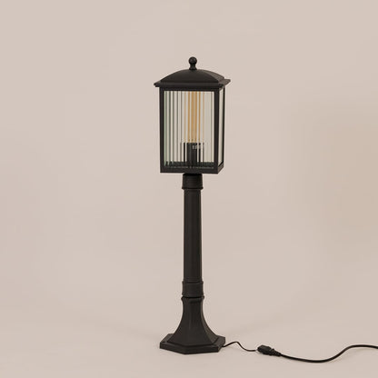 Black outdoor post light with ribbed glass shown switched off on white background perfect for outdoor entrances.