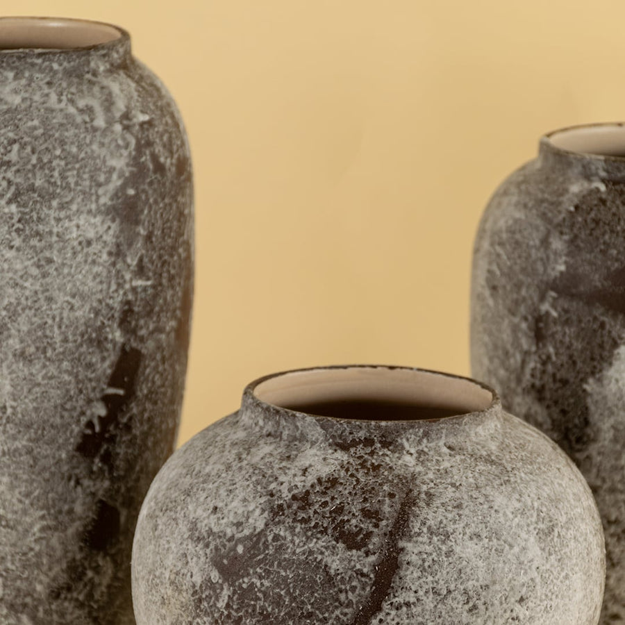 Artistic tall ceramic vase with rustic grey brown stone look finish crafted for elegant home interior decoration.