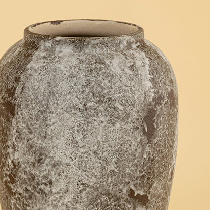 Handcrafted ceramic decor vase closeup showing textured stone finish and organic glazing details photographed on a soft neutral background highlighting surface depth.