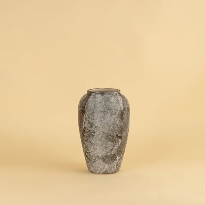 Rustic ceramic vase in grey brown textured stone look ideal for enhancing living room and entryway decor.