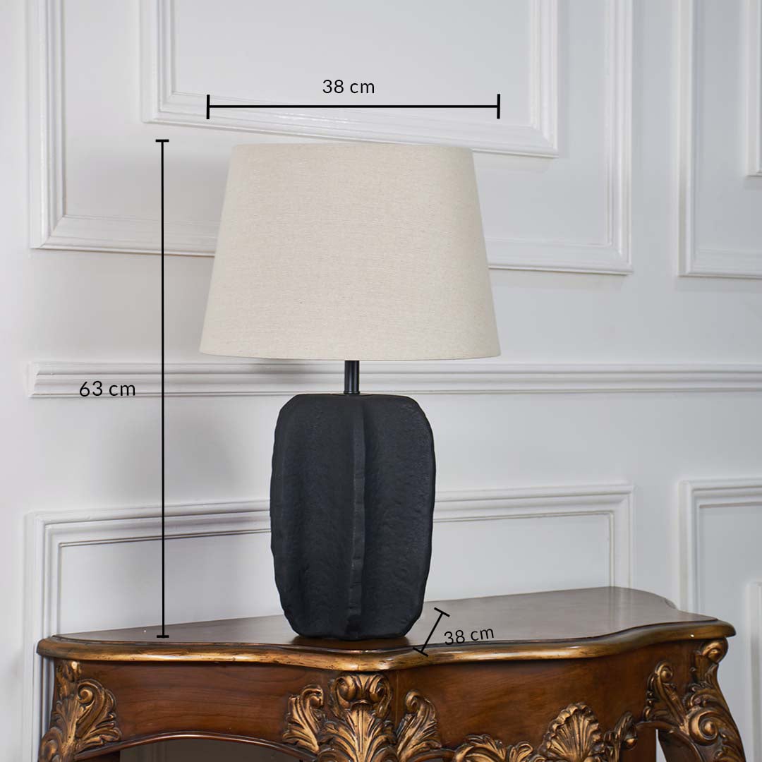 Modern black ceramic table lamp with beige fabric shade displayed on white background featuring height 63 cm width 38 cm and base diameter 38 cm for perfect size reference.