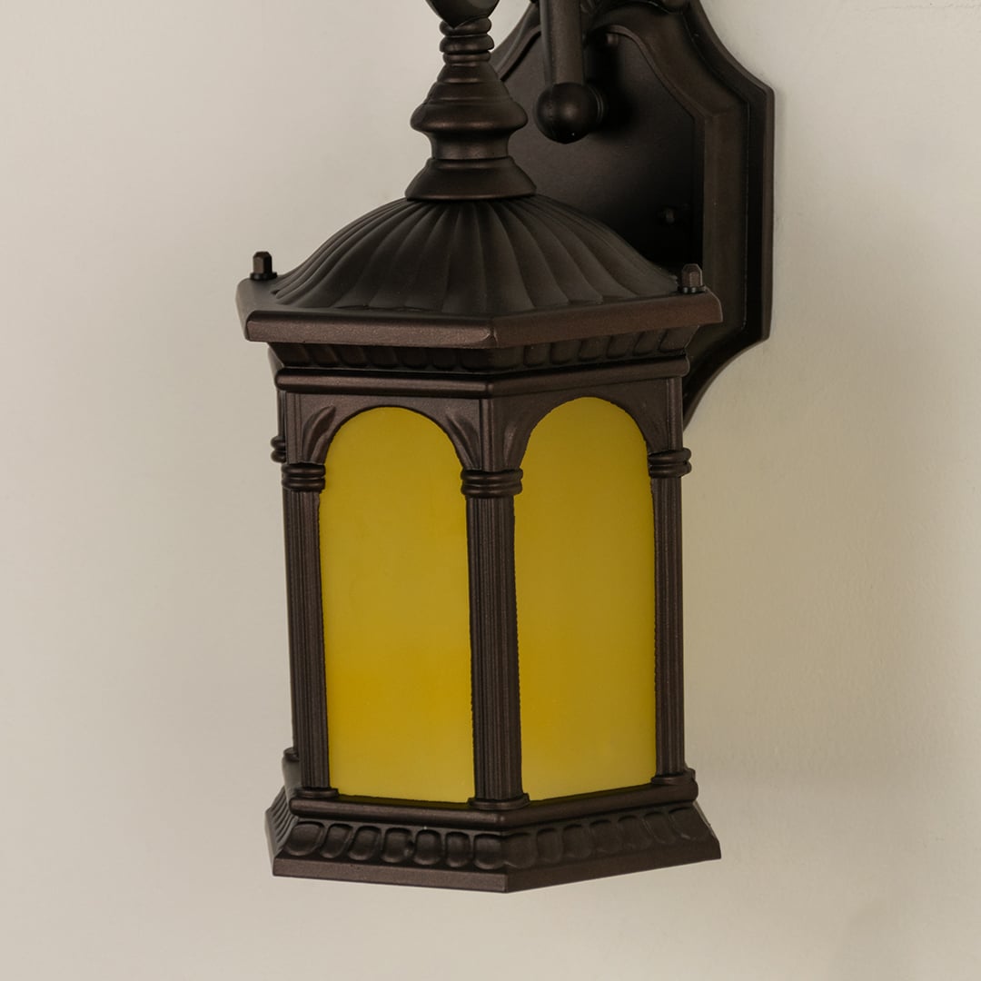 Closeup view of the large black metal outdoor lantern showing the detailed frame and the texture of the clear ribbed glass panels.