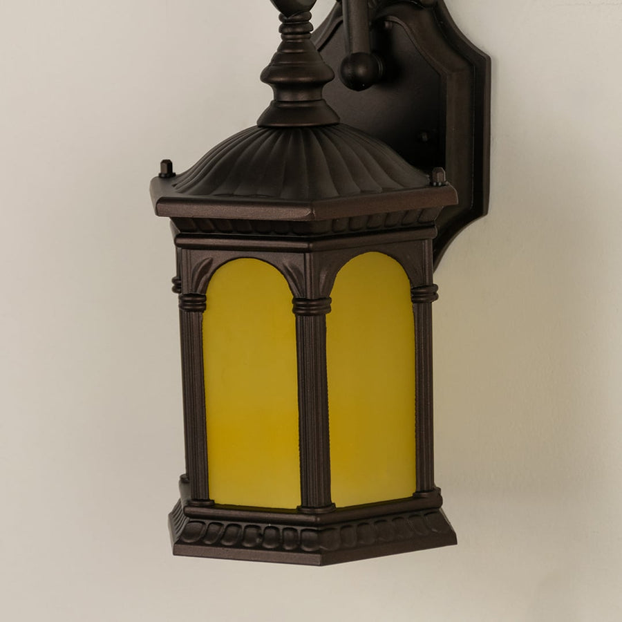Closeup view of the large black metal outdoor lantern showing the detailed frame and the texture of the clear ribbed glass panels.