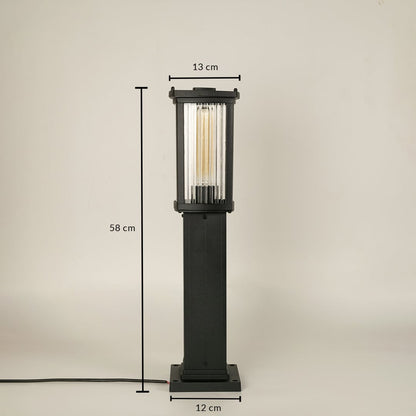A black outdoor bollard light on a white background with dimensions clearly marked showing a height of 58 cm a top width of 13 cm and a base width of 12 cm illustrating its proportional structure.