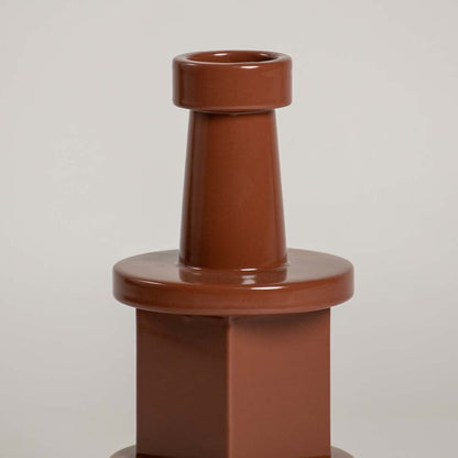 Closeup view of the brown geometric decorative vase focusing on its smooth glossy texture and bold layered structure that creates a striking contemporary accent.