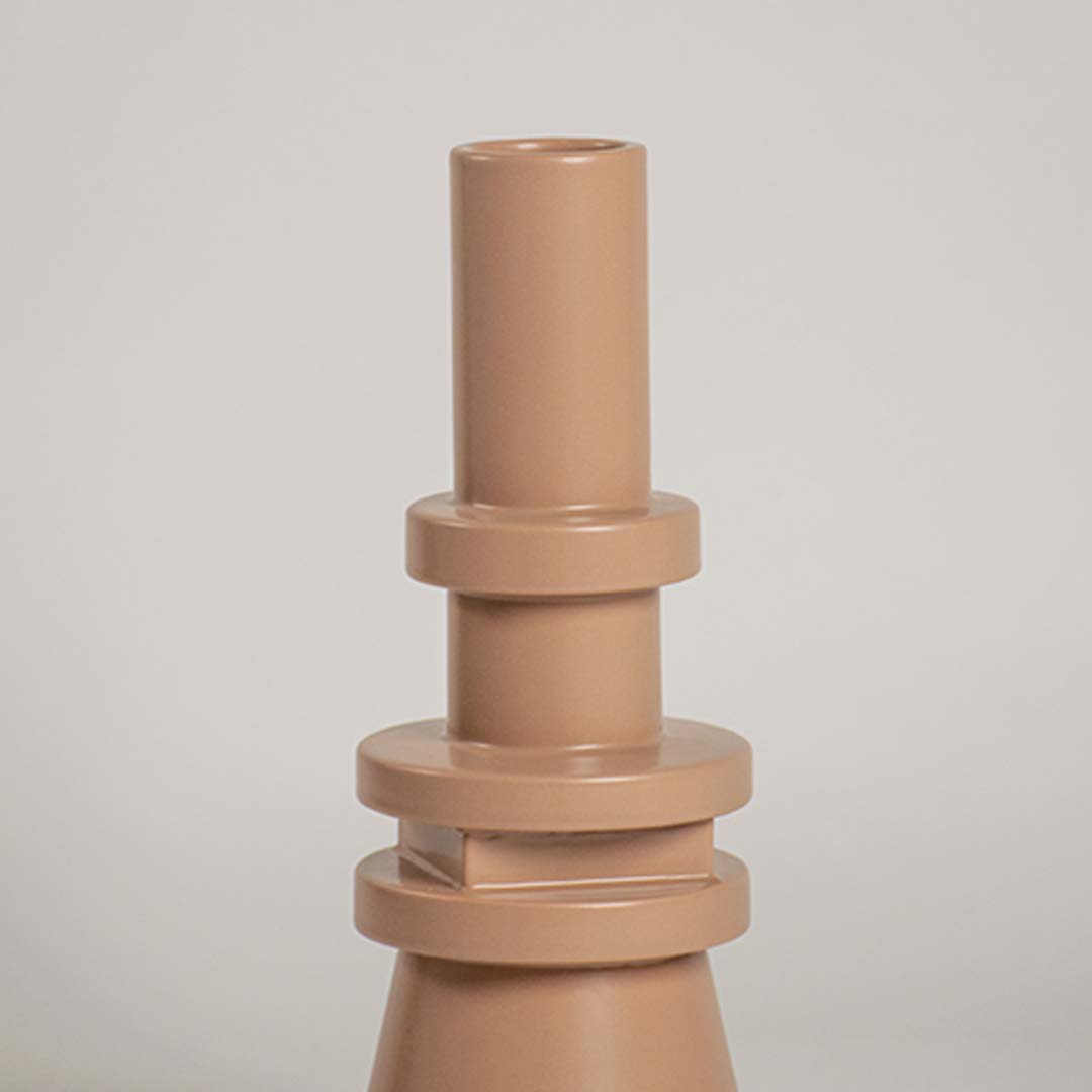Closeup view of the beige sculptural vase highlighting its layered geometric details and sleek smooth texture that add a bold artistic touch to decor.
