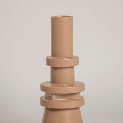 Closeup view of the beige sculptural vase highlighting its layered geometric details and sleek smooth texture that add a bold artistic touch to decor.