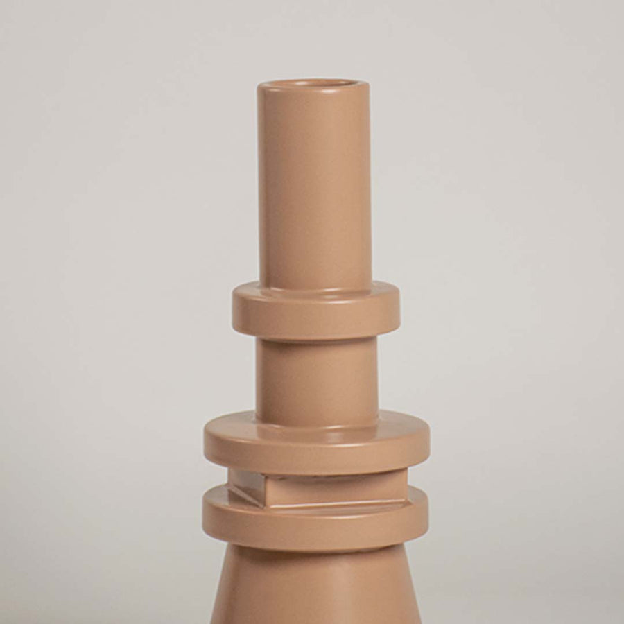 Closeup view of the beige sculptural vase highlighting its layered geometric details and sleek smooth texture that add a bold artistic touch to decor.
