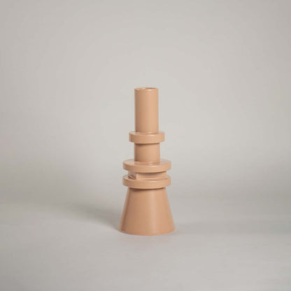 Contemporary beige vase set against a plain white backdrop showcasing its structured cone base and stacked circular accents for a stylish modern aesthetic.