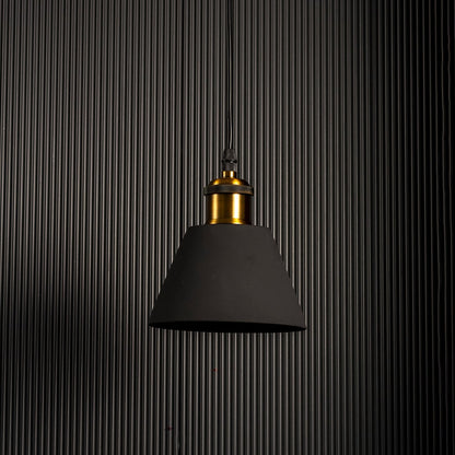 Minimal pendant light with matte black metal shade and brass holder styled for modern kitchen dining and studio interiors.