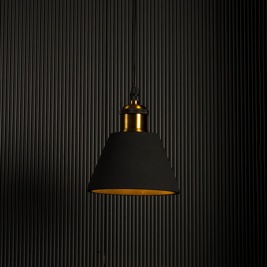 Black cone pendant lamp glowing brightly against a dark background highlighting its elegant modern shape.