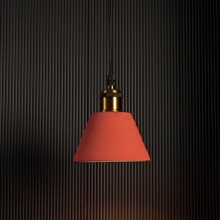 Terracotta cone pendant light glowing brightly against a dark background emphasizing its stylish silhouette.