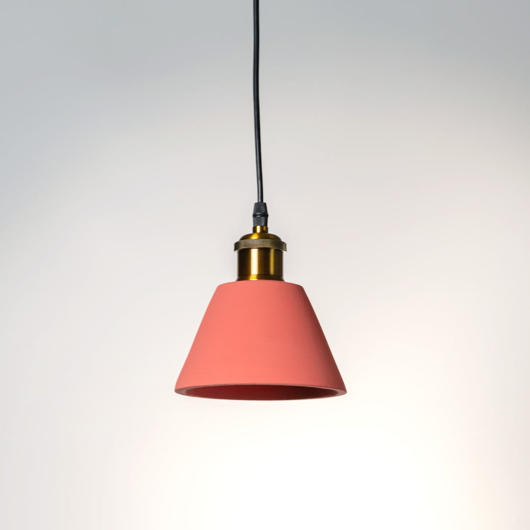 Terracotta cone pendant light turned off with elegant matte texture and golden brass detailing shown against a white background.