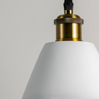 Closeup of cone pendant light turned off showing sleek brass fitting and smooth matte finish for elegant lighting design.