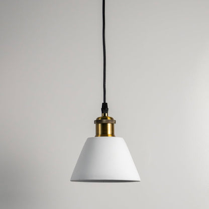 White cone pendant light turned off against white wall showcasing clean lines and brass top in minimal modern style.