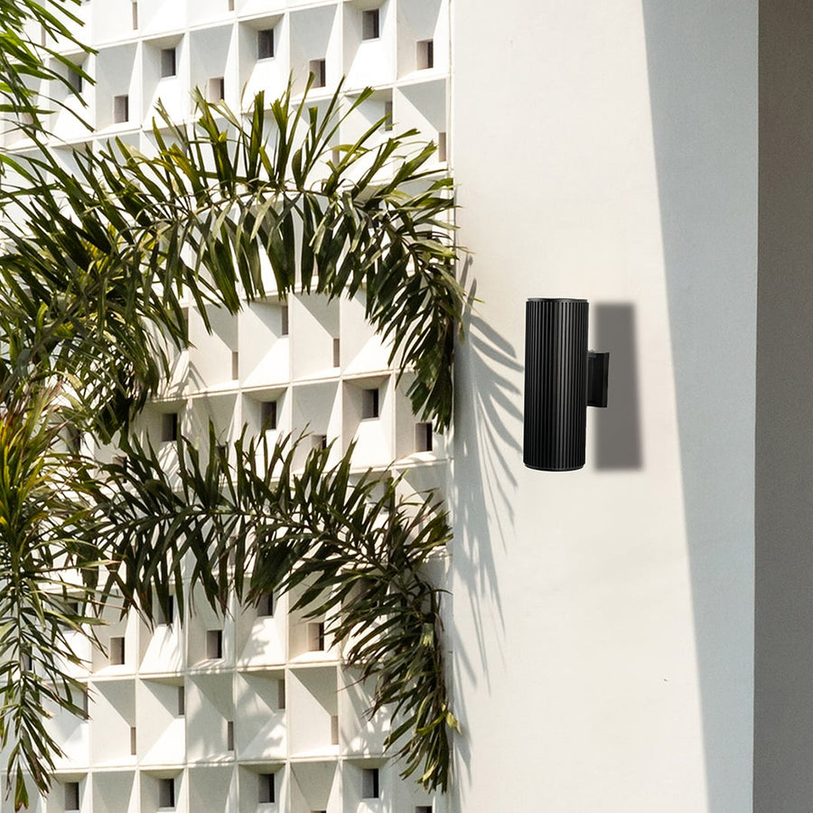 Modern black cylindrical wall light enhancing minimal interiors with balanced illumination and sophisticated charm.