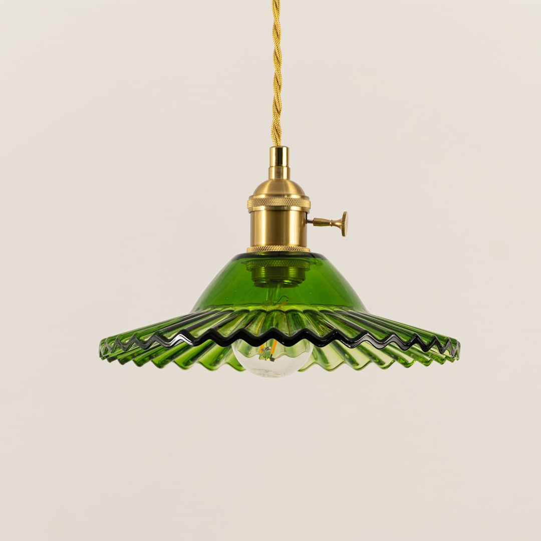Green scalloped metal pendant light with antique brass fittings designed for elegant modern interiors.