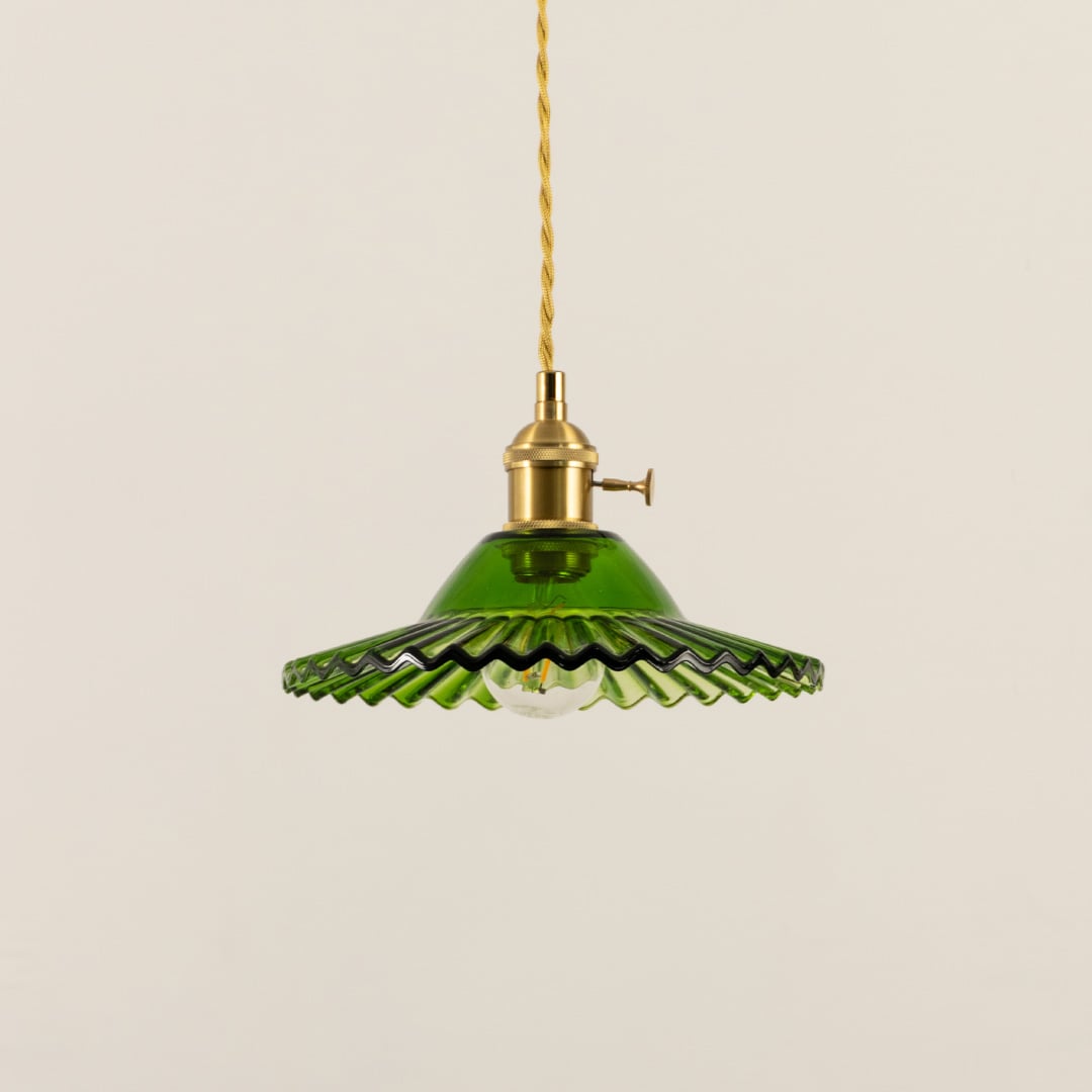 Green fluted metal pendant light with decorative scalloped edges crafted for dining and living spaces.