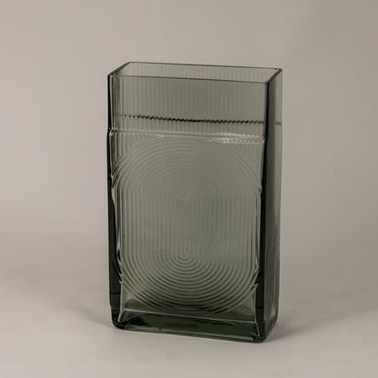 Side view of smoky gray textured glass vase highlighting its rectangular structure and reflective modern finish.
