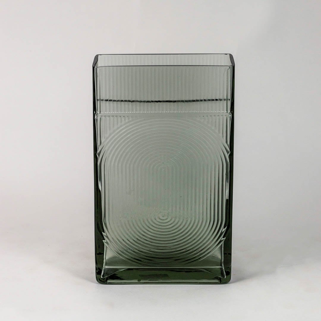 Smoky gray decorative glass vase with embossed circular pattern and glossy finish shown on clean white backdrop.