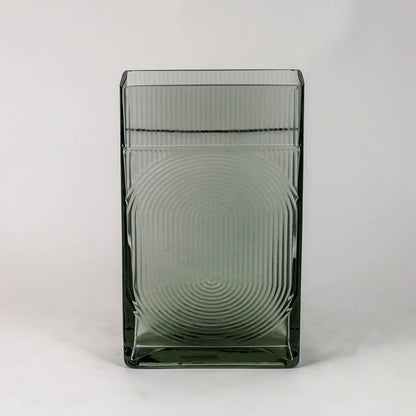 Smoky gray decorative glass vase with embossed circular pattern and glossy finish shown on clean white backdrop.