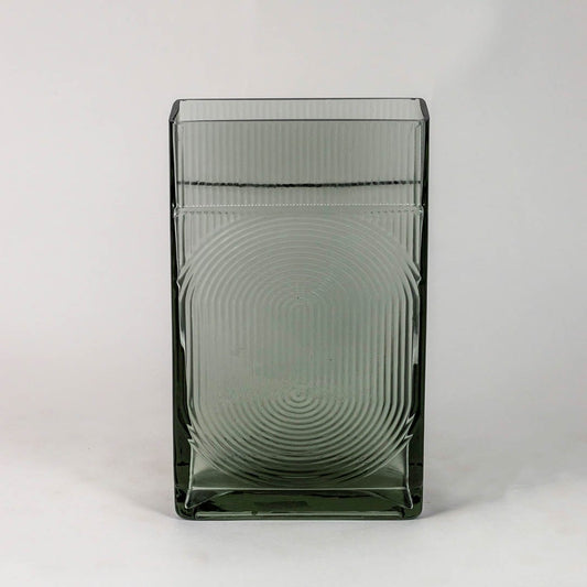 Smoky gray decorative glass vase with embossed circular pattern and glossy finish shown on clean white backdrop.