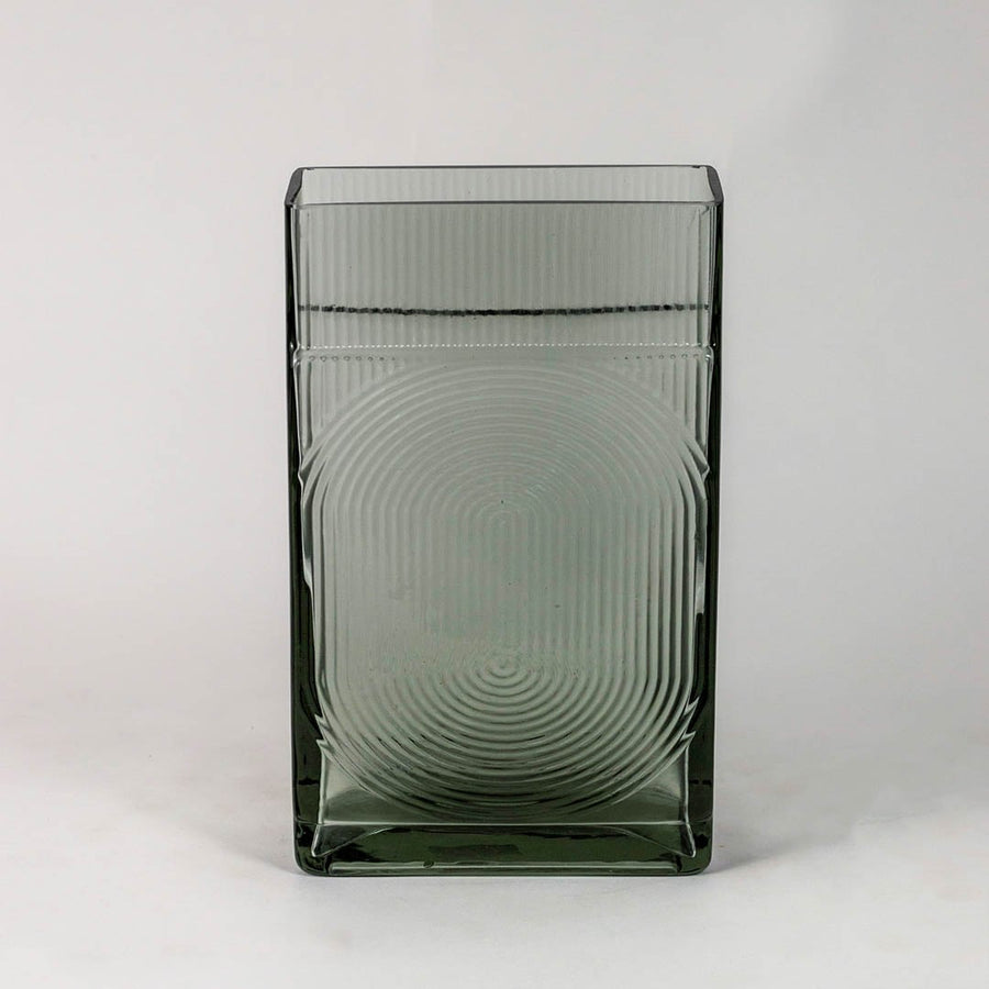 Smoky gray decorative glass vase with embossed circular pattern and glossy finish shown on clean white backdrop.