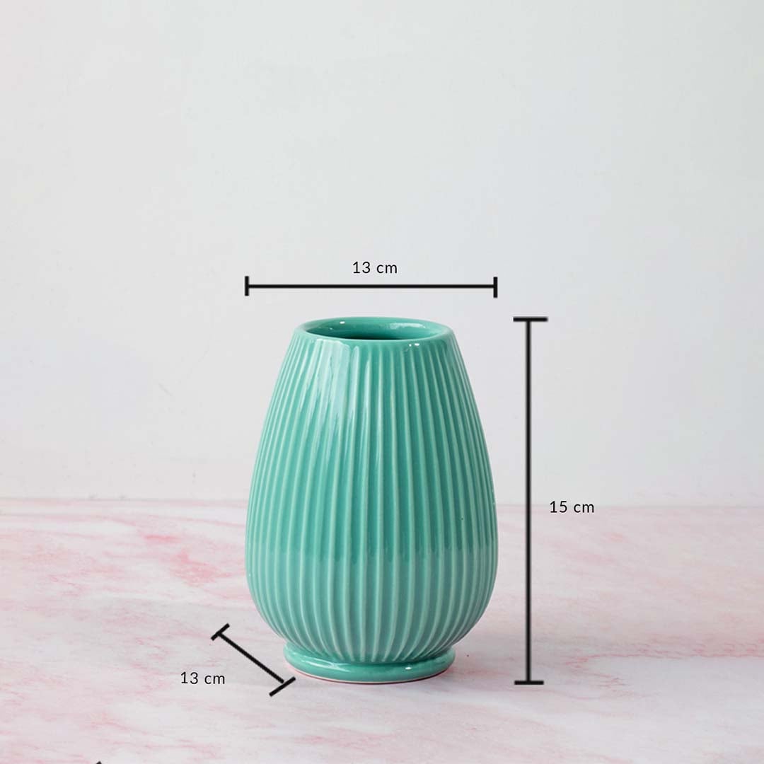 Textured ceramic vase in teal finish showing approx twenty two cm height and thirteen cm diameter designed for table and shelf decor.