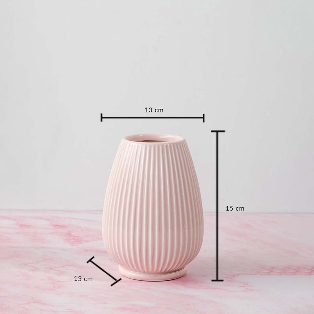 Pink ceramic vase with height 15 cm and width 13 cm shown on a pink marble surface for size reference.
