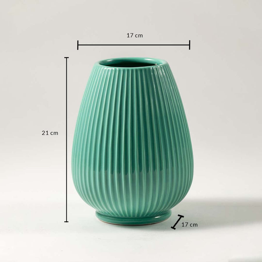 Green ceramic vase with ribbed design dimensions 21cm height and 17cm width for flowers and table decor.