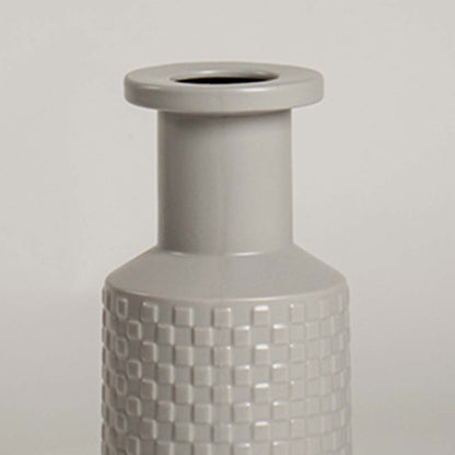 Closeup of light grey ceramic vase highlighting its embossed textured design and smooth finish ideal for stylish modern home decor.