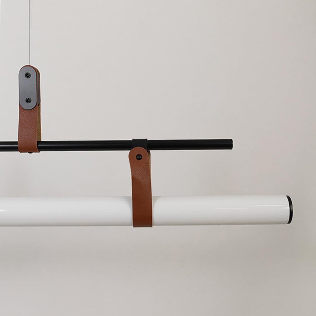 Black metal linear LED pendant light showcasing premium craftsmanship with leather strap accents and modern design details.