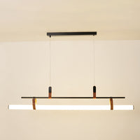 Black metal linear LED pendant light with integrated illumination creating sleek modern ambient ceiling lighting indoors.