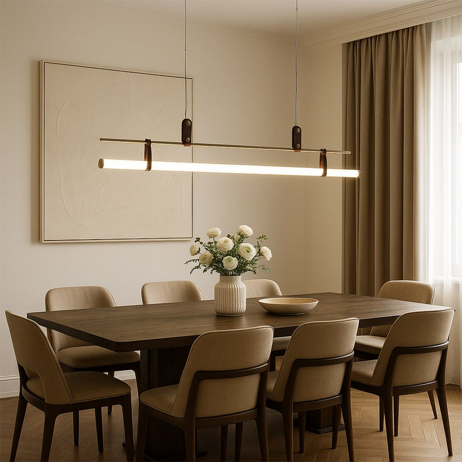 Gold and white linear pendant light styled above a dining table creating warm refined illumination in a modern home.