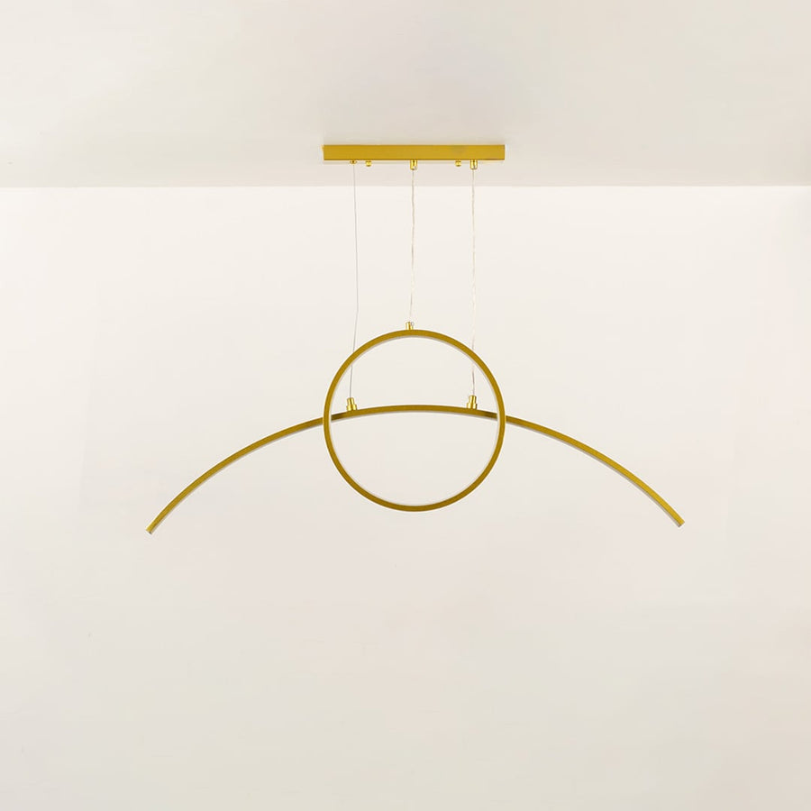 Minimal gold metal wall light with curved linear design shown unlit on black background for modern architectural lighting decor.