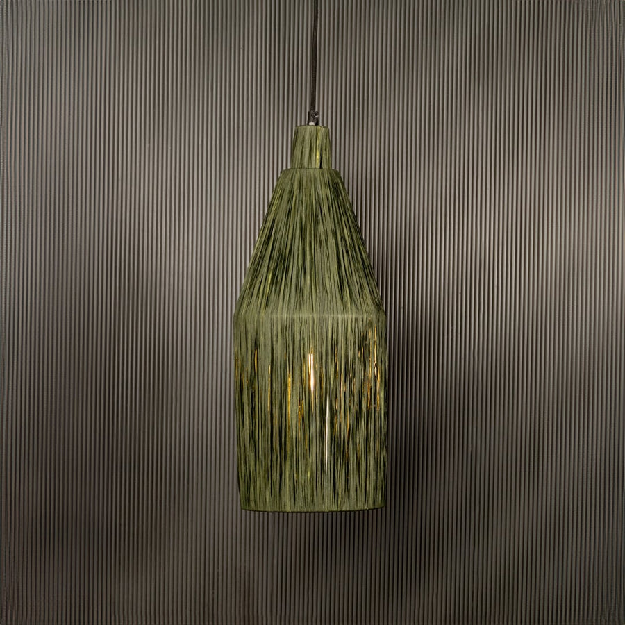 Green ribbed glass pendant light illuminated warmly adding vintage charm to indoor spaces.