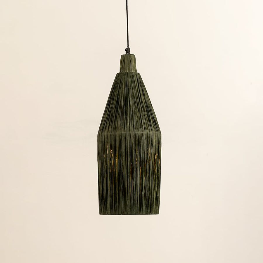 Green woven fiber pendant light illuminated to highlight textured craftsmanship and modern organic lighting design.