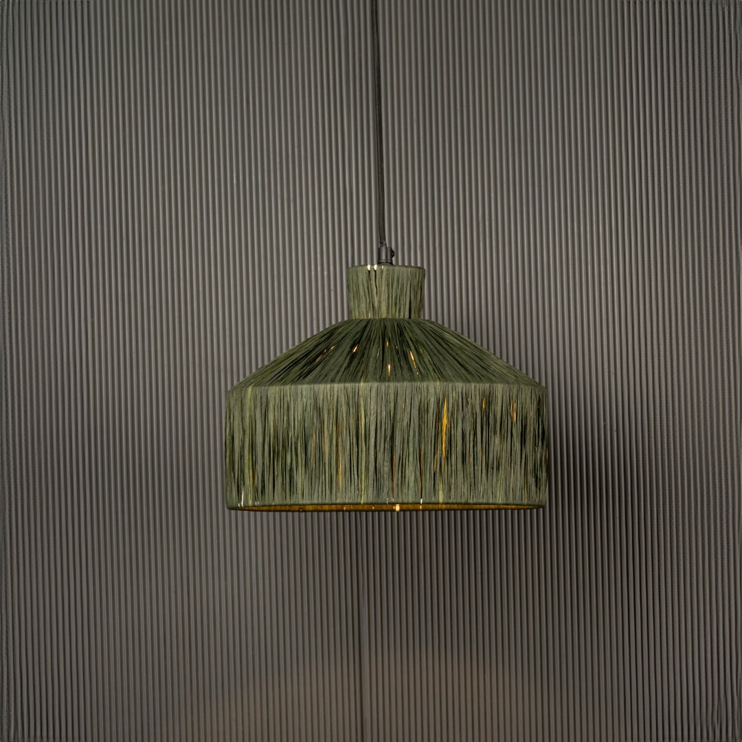 Green woven pendant light with a geometric shape glowing softly and adding a natural textured highlight that brings a handcrafted touch to the space.