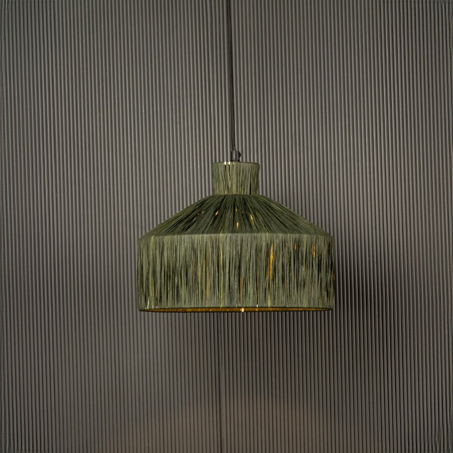 Green woven pendant light with a geometric shape glowing softly and adding a natural textured highlight that brings a handcrafted touch to the space.