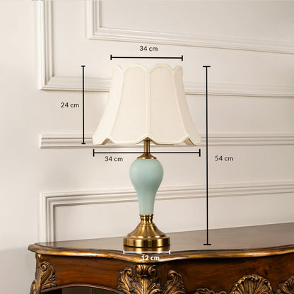 Classic table lamp with beige shade measuring 54 cm in height and 34 cm in width featuring a light blue ceramic base with metallic gold detailing.