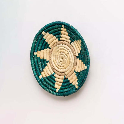 Side angle of green and beige woven bamboo wall plate showing handcrafted depth perfect for ethnic wall accent.