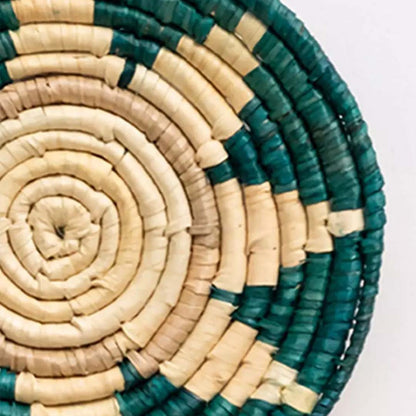 Detailed view of handwoven bamboo wall plate showing spiral texture and green beige pattern for artistic wall decor.