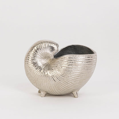 Silver textured nautilus shell decor piece placed on a white backdrop showcasing its handcrafted detailing