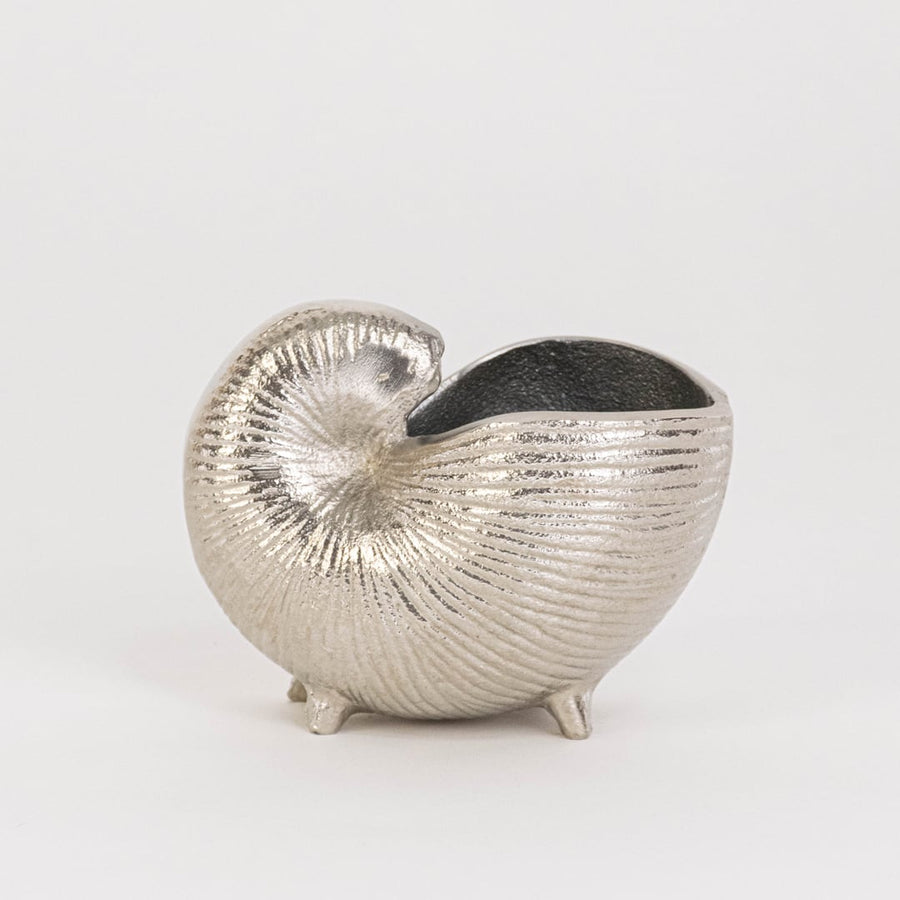 Silver textured nautilus shell decor piece placed on a white backdrop showcasing its handcrafted detailing